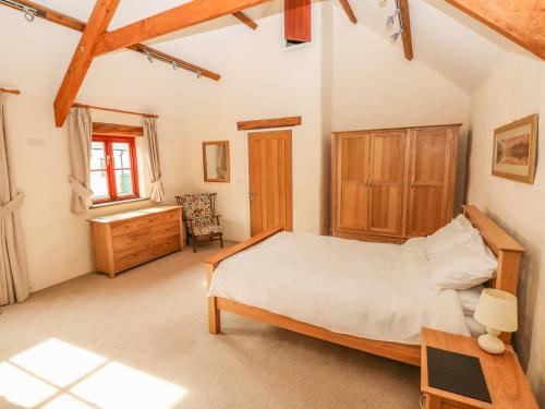 a bedroom with a bed and a desk in a room at Maerdy Lodge in Haverfordwest