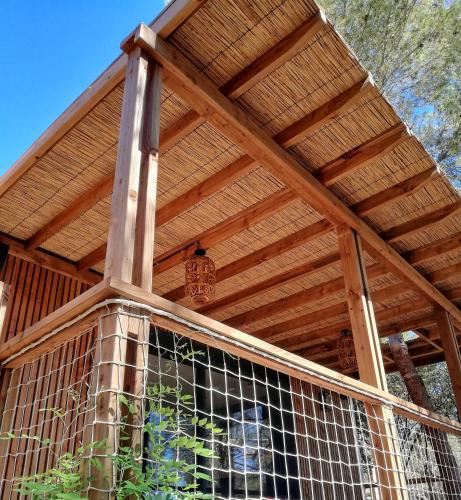 a wooden pergola on top of a house at Villa Occitana in Calvisson