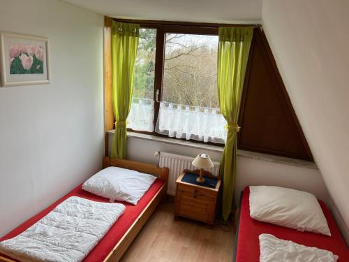 two beds in a small room with a window at Ferienwohnung in Süsel am See in Süsel