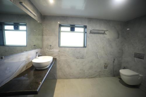 a bathroom with a sink and a toilet at The Byke Heritage Resort - Matheran in Matheran