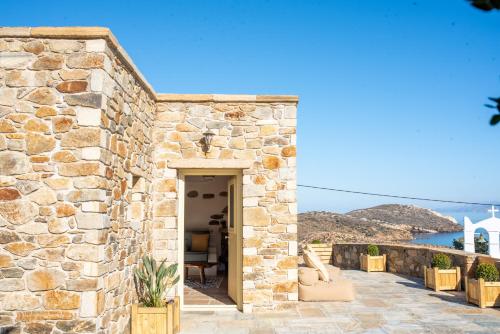 a stone building with a door and a patio at Anthoula's House in Psathi