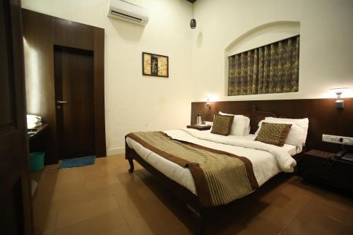 a bedroom with a large bed in a room at The Byke Heritage Resort - Matheran in Matheran