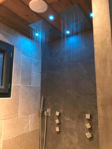 a bathroom with a shower with blue lights at Villa Occitana in Calvisson