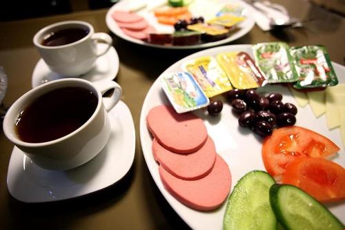 a table with a plate of food and a cup of coffee at Metrolux Hotel in Istanbul