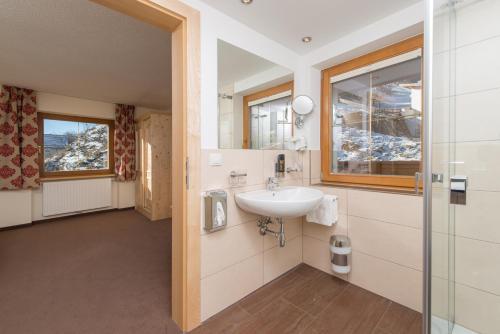 a bathroom with a sink and a window at Apart Krismer in Ladis