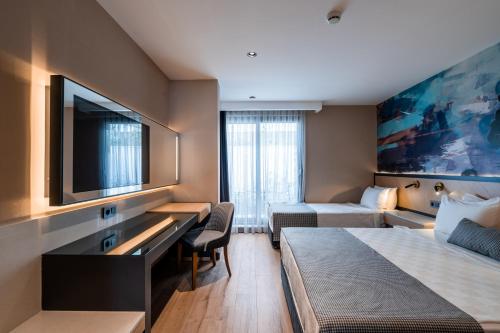 Katil atau katil-katil dalam bilik di Ni Hotel Lara