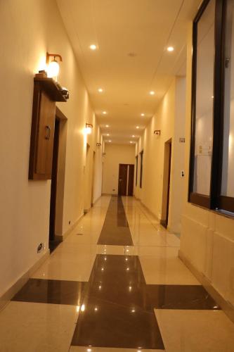 a hallway of a building with a long corridor at Hotel Pushap Palace in Patiāla