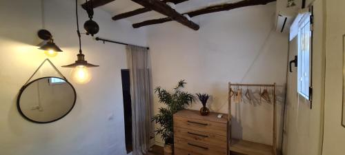 a hallway with a mirror and a wooden dresser at White Fish Mojacar in Mojácar