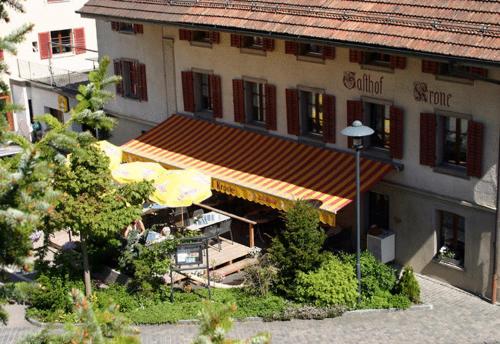 a building with an umbrella in front of it at Gasthof Krone in Luthern