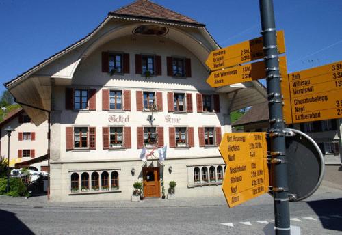 a building with many street signs in front of it at Gasthof Krone in Luthern