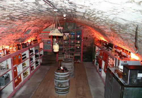 a wine shop with a red ceiling and a tunnel at Gasthof Krone in Luthern