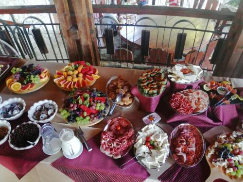 een tafel met veel verschillende soorten voedsel bij CLUB D'OR in Vama Veche