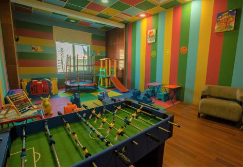 a childrens play room with a pool table in it at City Tower Hotel in Kuwait
