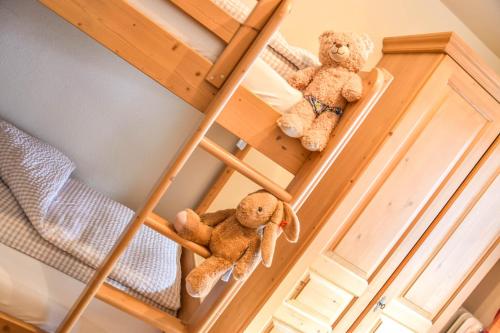 two teddy bears sitting on a bunk bed at Haus Franzi in Steeg
