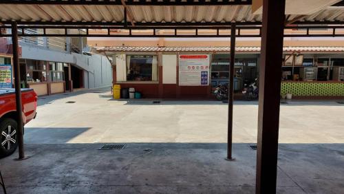 an empty parking lot in front of a building at Sataya Apartment in Maha Sarakham