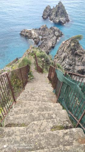 a staircase leading down to the ocean with a fence at B&B Centro Storico 900 in Palmi