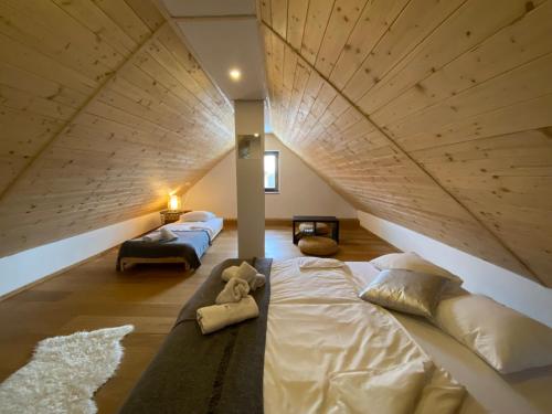 a bedroom with a large bed with a wooden ceiling at GORIČKE IŽE in Križevci
