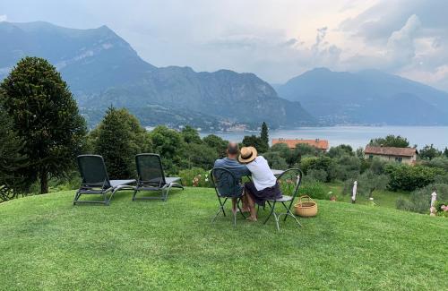 a man and a woman sitting in chairs in a field at Il Poggio Di Bellagio in Bellagio