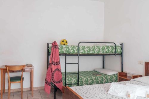 1 Schlafzimmer mit Etagenbetten, einem Schreibtisch und einem Stuhl in der Unterkunft Family Room Casa Vacanze in Marcelli