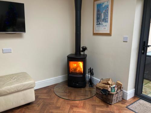 a living room with a fireplace in the corner at Shrewsbury Cottage in Shrewsbury