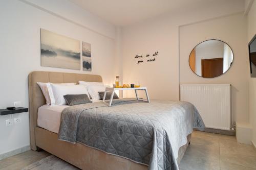 a bedroom with a large bed and a mirror at Diamond Palace Trikala in Tríkala