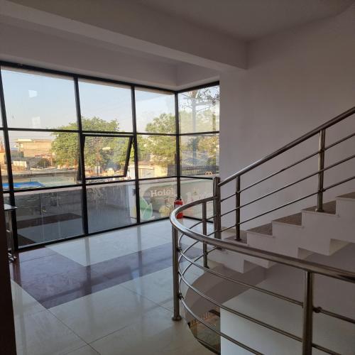 a staircase in a building with a large window at Shivani Inn Hotel & Banquet in Seonī