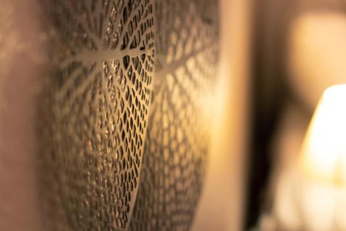 a wall with a white paper pattern on it at Le President-Gare Nimes Pont Du Gard in Bellegarde