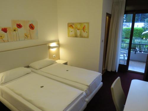 Tempat tidur dalam kamar di Hotel Villa Claudia