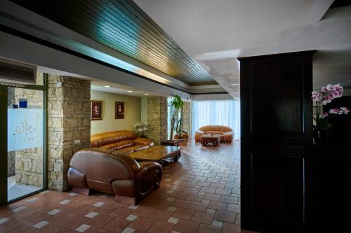 a living room with leather couches and a table at Hotel & Restaurant Sofia in Suceviţa