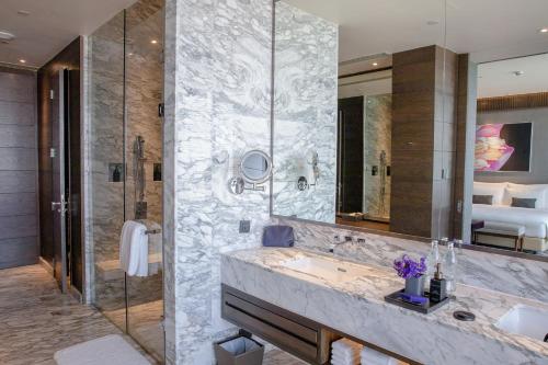 a bathroom with a sink and a shower at 137 Pillars Suites Bangkok in Bangkok