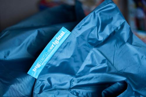 a hand holding a blue plastic bag with a tag on it at Tanamuir, overlooking Loch Fyne, Strachur in Cairndow