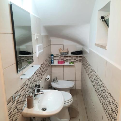 a bathroom with two toilets and a sink at Appartamento Limone in Cala Gonone