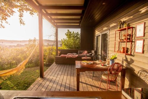 a screened in porch with a table and a couch at Gato Preto de Silves - Adults Only in Silves