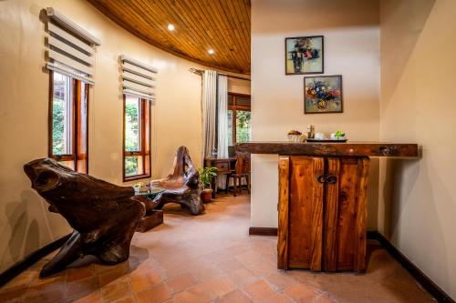 a living room with a wooden counter in a room at Divine Resort & Spa in Kampala