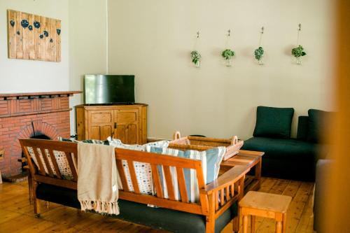 sala de estar con mesa, sillas y chimenea en Crompton Cottage, en Henburg Park