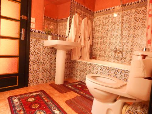 a bathroom with a toilet and a sink at Casa del Sol Marrakech in Marrakech