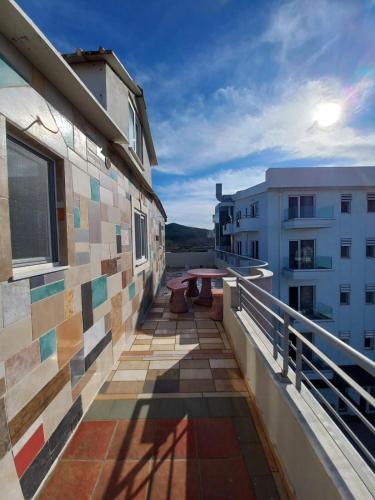 a balcony with a table on the side of a building at Arjana & Nelaj Apartments in Ksamil