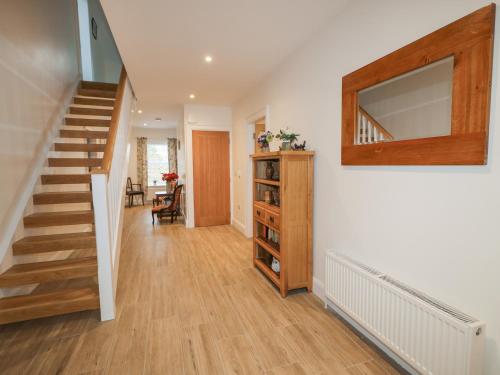 a hallway with a staircase and a stair case at Sliabh Amharc in Downpatrick