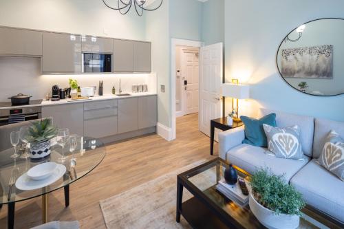 a living room with a couch and a table at Redmayne House - Urban Apartments in Bristol