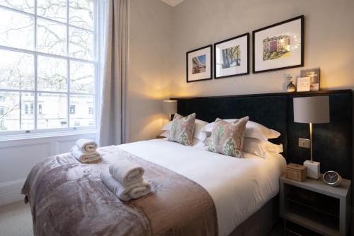 a bedroom with a large bed with towels on it at Redmayne House - Urban Apartments in Bristol
