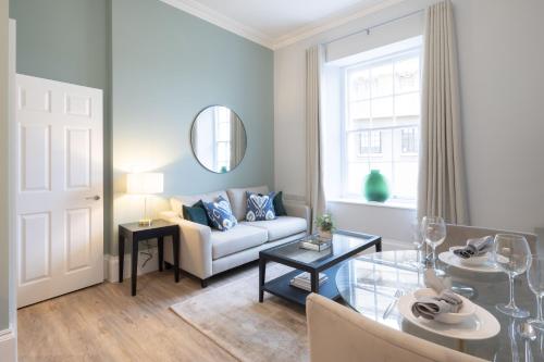 a living room with a couch and a table at Redmayne House - Urban Apartments in Bristol