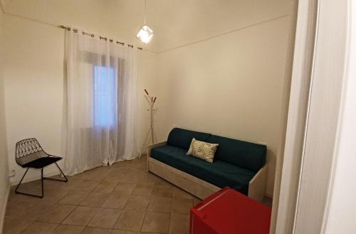 a living room with a couch and a window at Casa Maja rooms & suites in Favignana