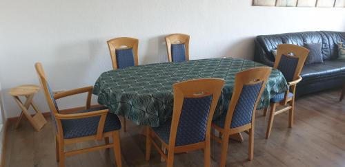 a dining room table with chairs and a couch at Oktopus in Hannover