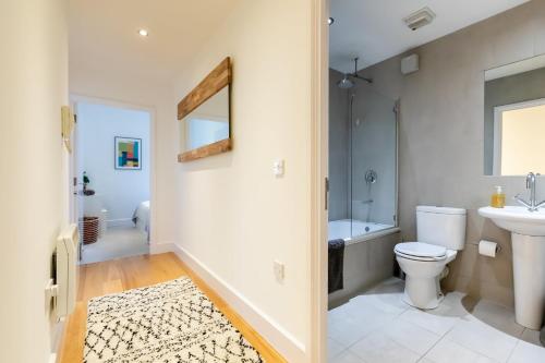 a bathroom with a toilet and a sink at Modern and Spacious 1 Bed Apartment City Centre in Norwich