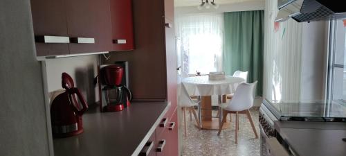 a kitchen with a small table and a table and chairs at Ferienwohnung Wicke in Thale
