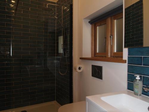 a bathroom with a sink and a glass shower at Bruckton Stables Annex in Dartmouth