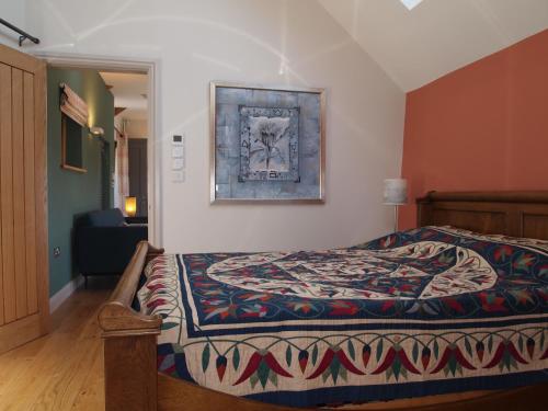 a bedroom with a bed with a rug on it at Bruckton Stables Annex in Dartmouth