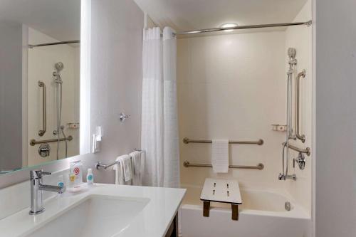 a white bathroom with a sink and a shower at Comfort Inn Jonesboro in Jonesboro