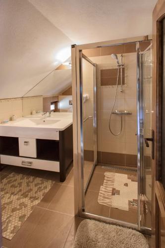 a bathroom with a shower and a sink at Pensiunea Cretuca in Botiza