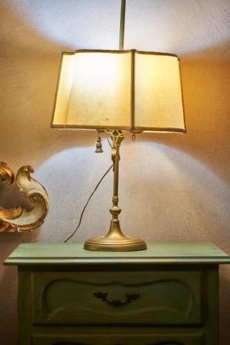 a lamp sitting on top of a dresser at Alla Scala 1746 in Siena